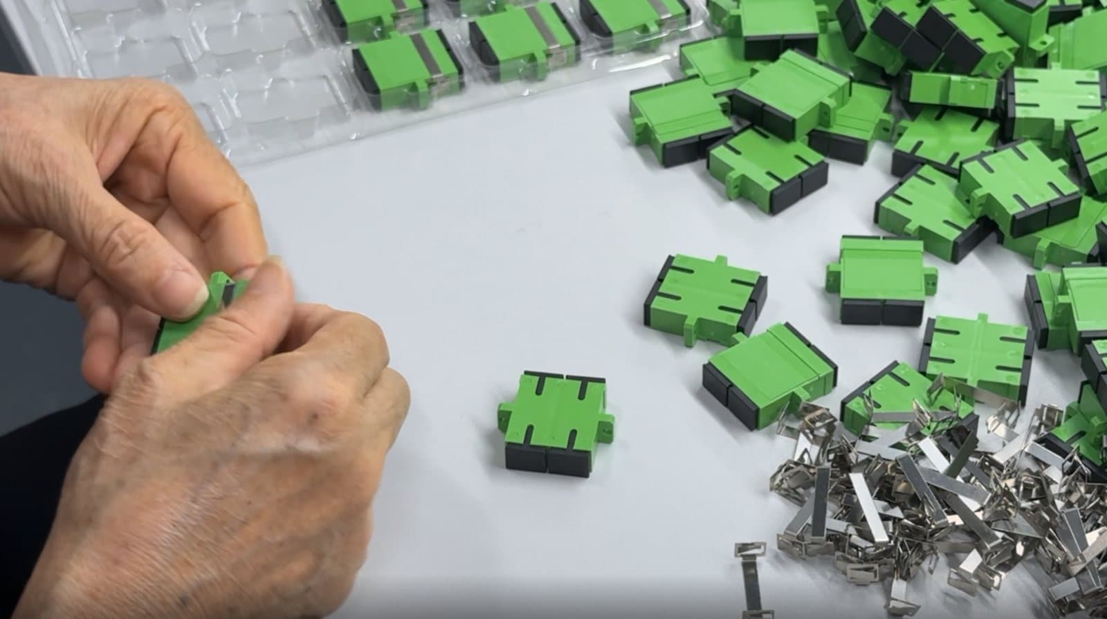 Operator preparing fiber optic connector components