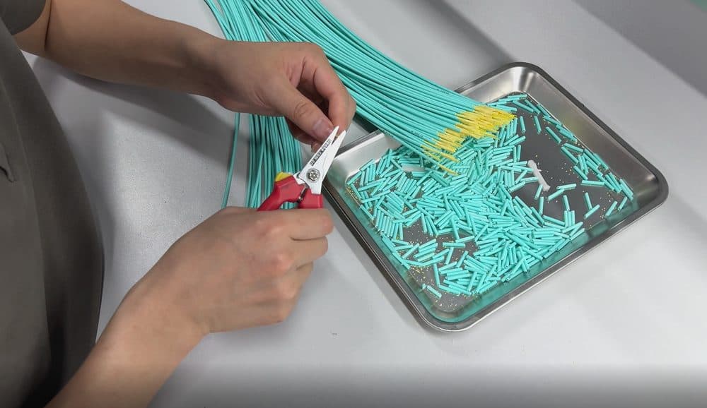 Operator organizing fiber assemblies in tray