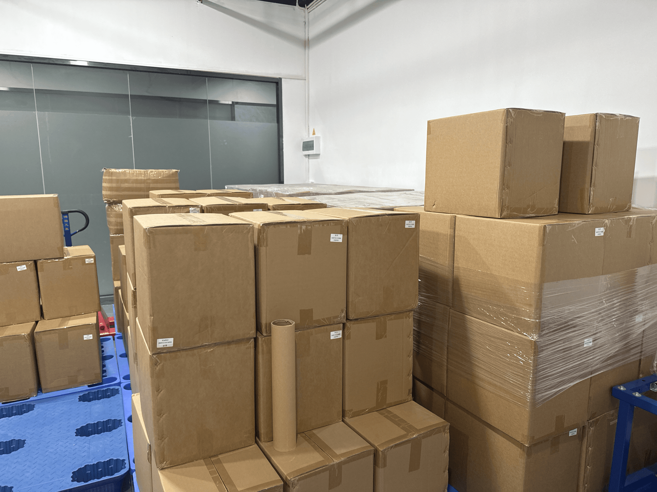 Packed neutral cartons stacked in the shipment room