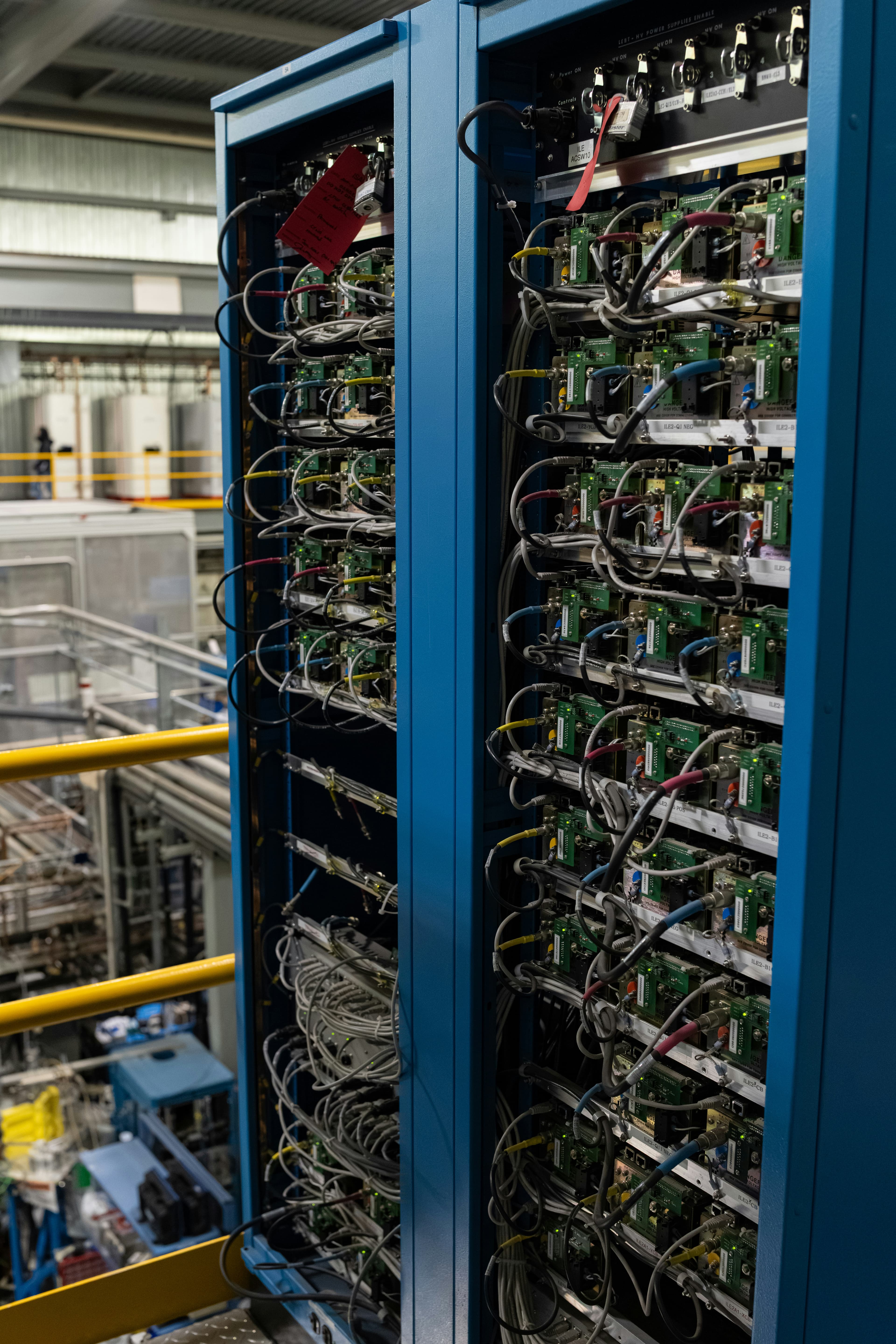 Engineers reviewing fiber connectivity requirements at network racks